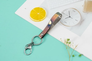 Close-up of iridescent PVC keychain lanyard with gradient metallic effect and silver clasp