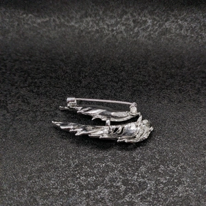 Silver feather wing brooch with sparkling rhinestones shown from a 45-degree angle