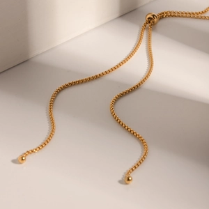Detail of adjustable 18k gold plated stainless steel box chain with sliding gold bead