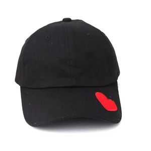 Detail of red heart patch on black cotton twill baseball cap with curved brim style