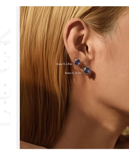 Model wearing 7mm and 8mm round blue tanzanite silver stud earrings for size comparison