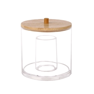 Detail view of transparent acrylic storage jar featuring a natural bamboo lid and inner divider