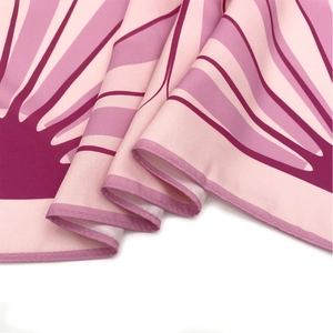 Detail of floral silk scarf showing premium twill texture and neat rolled edges