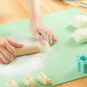Silicone kneading mat and wooden rolling pin set for baking, dough rolling surface.