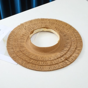 Close-up of a straw sun hat featuring a unique triple-layered fringe wide brim design