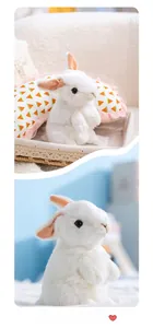 Detailed close-up of a white plush rabbit toy with soft long fur and pink ear accents