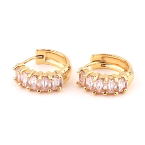 Detailed close-up of golden hoop earrings featuring square-cut zirconia in a prong setting