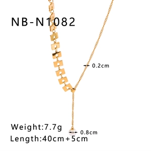Detailed spec view of gold Y-necklace with asymmetric square charm and 8mm pearl pendant
