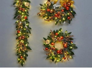 Detail of Christmas wreath and teardrop garland with champagne gold ornaments and LED lights