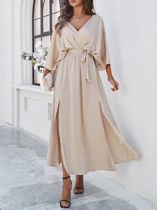 Detail view of champagne satin maxi dress featuring V-neckline and elegant waist tie