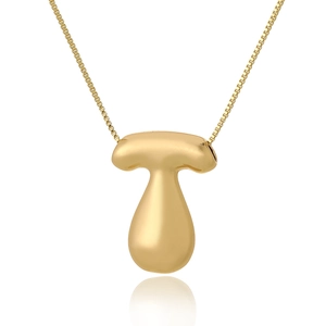 Detailed view of the gold balloon letter T pendant on a box chain necklace with mirror reflection