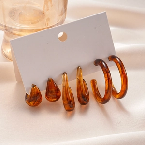 Set of 6 amber acrylic tortoise shell earrings in drop and hoop shapes on card