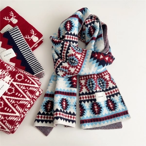 Winter long knitted scarf with festive geometric patterns and cozy knit texture