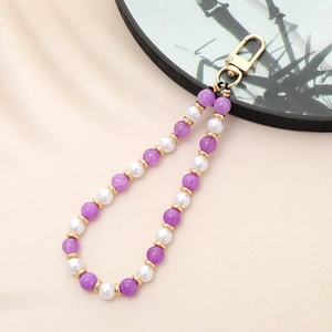 Premium phone strap with natural purple amethyst and white turquoise beads on beige texture