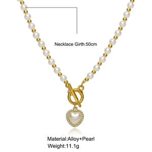 Detail view of heart pearl pendant necklace with OT clasp and 50cm length measurement