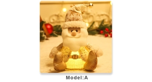 Close-up of glowing Santa Claus figurine with white fabric and golden sequins detail