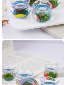 Detailed macro view of a miniature resin fish tank with colorful koi and aquatic plants