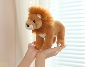 Close-up of a soft plush lion toy with fluffy mane being held in hands by a bright window