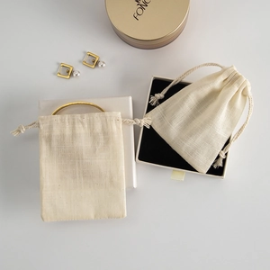 Detail of natural cotton linen drawstring bags and jewelry gift boxes with soft lining