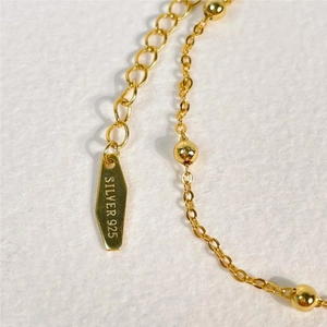 Macro shot of 925 silver gold-plated extension chain with Silver 925 engraving tag