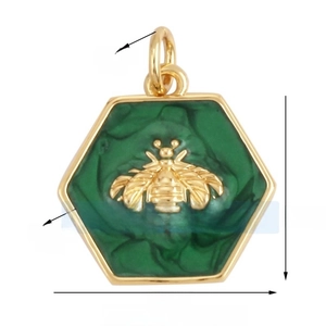 Macro shot of a hexagonal gold pendant featuring a green enamel inlay and a 3D bee motif