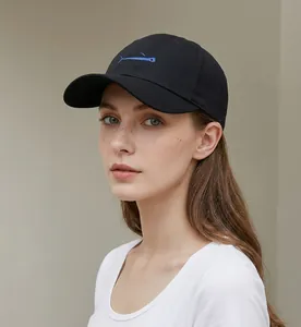 Detailed close-up of a black baseball cap featuring a blue whale embroidery on the front