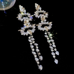 Macro view of crystal teardrop fringe earrings with silver base and marquise stones