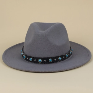 Detailed view of gray wool fedora hat with turquoise gemstone and silver studs decoration