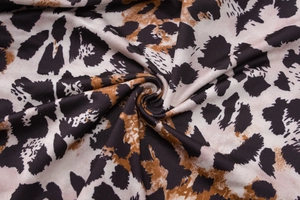Detailed macro view of soft leopard print fabric with smooth drape and rich texture