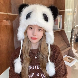 Close-up of plush panda winter hat with faux fur ear flaps for warm head protection