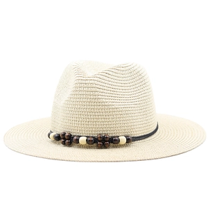 Detail of Panama hat with breathable weave texture and bicolor wooden bead strap