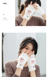 Detail of white faux mink fingerless gloves featuring pink cat paw print and button