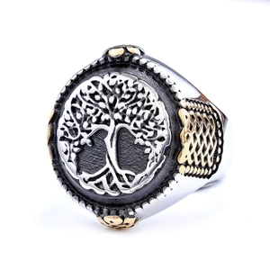Detailed close-up of Tree of Life signet ring with Celtic knot patterns in steel gold finish