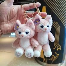 Detailed view of pink plush fox keychains with purple flower details and golden chain links