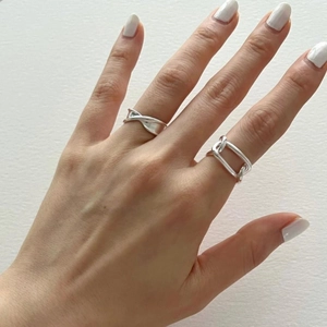 Detail of 925 sterling silver geometric rings and Mobius twist ring on hand