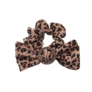 Leopard print bow scrunchie with a sparkling rhinestone metal ring on white background