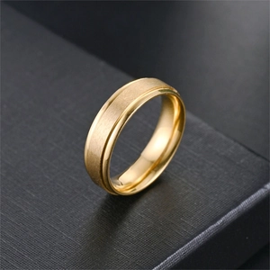 Close-up of 6mm titanium steel ring featuring matte finish and polished golden edges