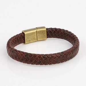 Close-up of woven dark brown leather bracelet with antique bronze magnetic metal clasp