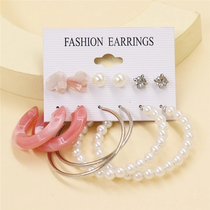 Detailed display of a 6-pair gold earring set with pearls and pink resin on a display card