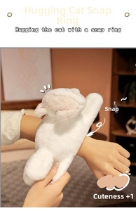 Close-up of white plush cat snap bracelet worn on wrist showing soft fur detail