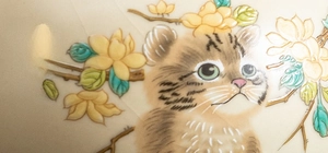 Macro detail of hand-painted cat and flowers on Ru Kiln ceramic teapot with crackle glaze