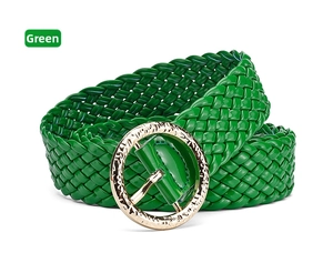 Macro detail of glossy green braided belt with textured gold round metal buckle