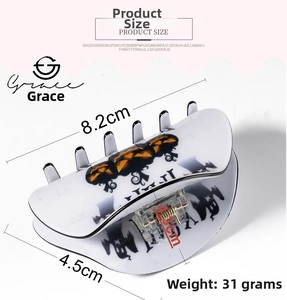 Detailed view of Halloween hair claw clip showing 8.2cm size and pumpkin pattern
