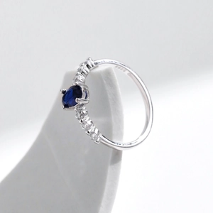 Elegant S925 sterling silver ring with oval blue gemstone and side cubic zirconia