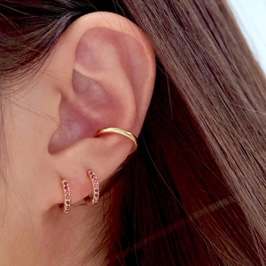 Classic gold hoop earrings set with red cubic zirconia and minimalist ear cuff