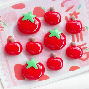 Detailed view of red resin tomato charms in various sizes for DIY crafting and jewelry