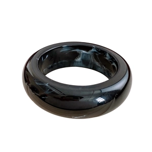 Polished resin bangle featuring a modern black and white marble pattern design