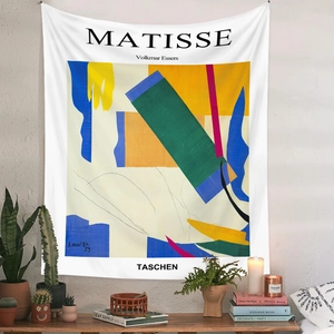 Detail of Matisse abstract art tapestry hanging above a candle and wooden table