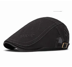Detail of adjustable metal buckle and grey cotton twill texture on a retro flat cap