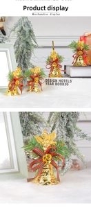 Detail of golden Christmas bell with an angel sculpture and festive bow decoration